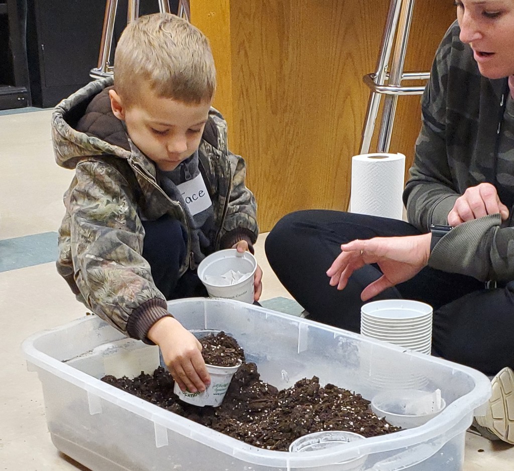 WBE PreK students planting shamrocks