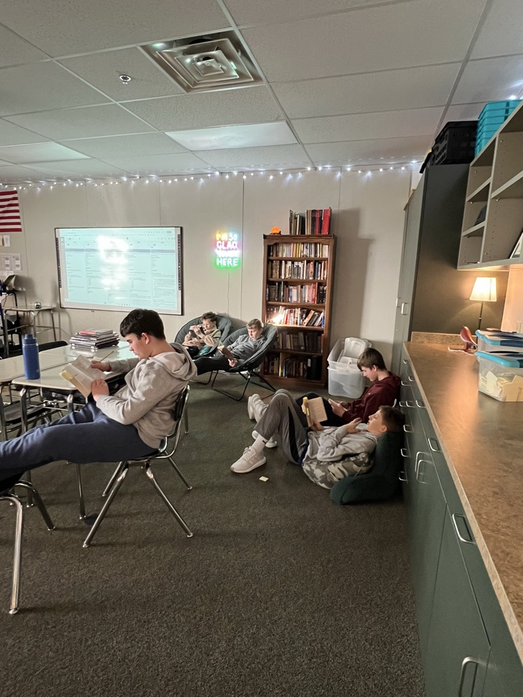 students reading on the floor and in chairs