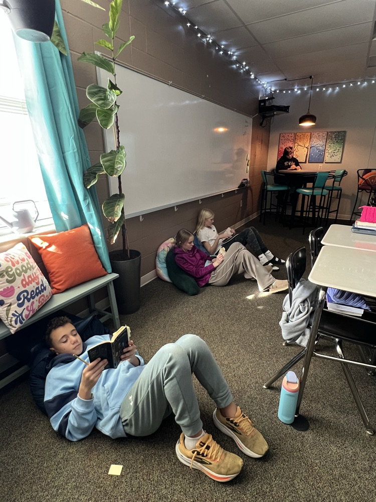 students reading on the floor and at a table