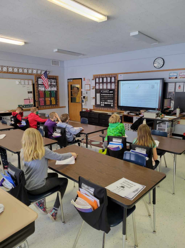 Students look up at a screen.