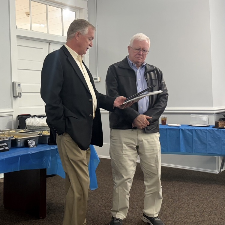 Wes Taylor presents a plaque to Bobby Smith.