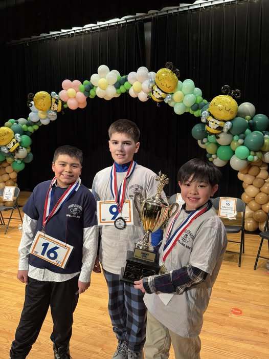 Young boys with metals and a trophy smiling. 