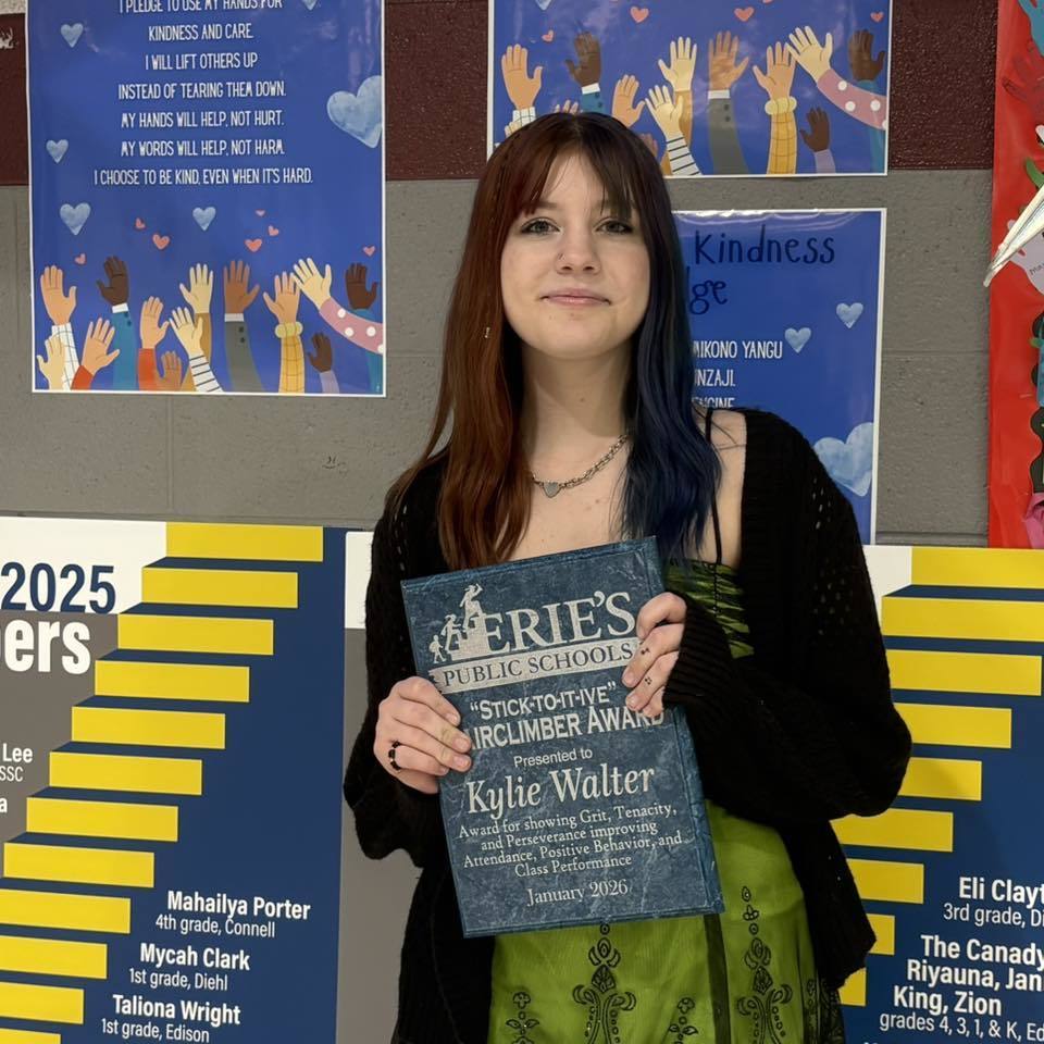 Young girl holding her award. 