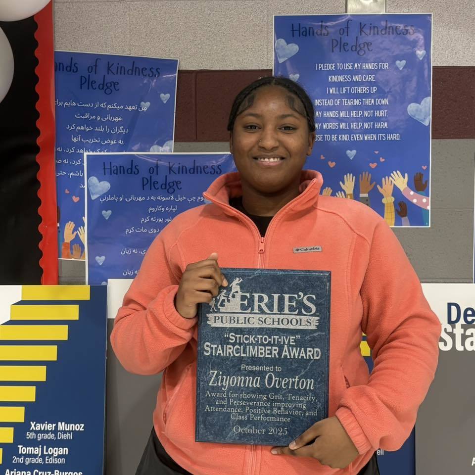Young girl holding her award. 