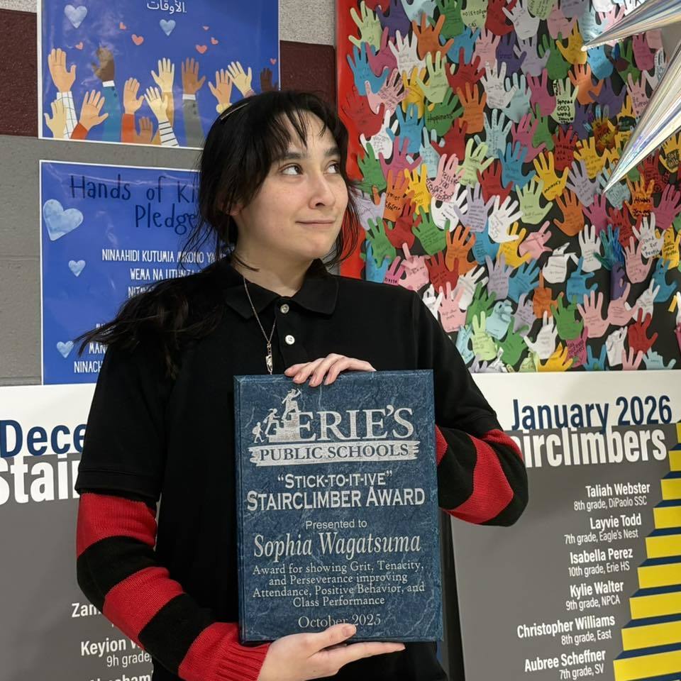 Young girl holding her award. 