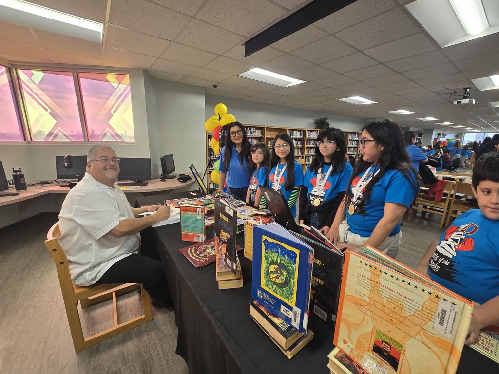 students and teacher standing around table