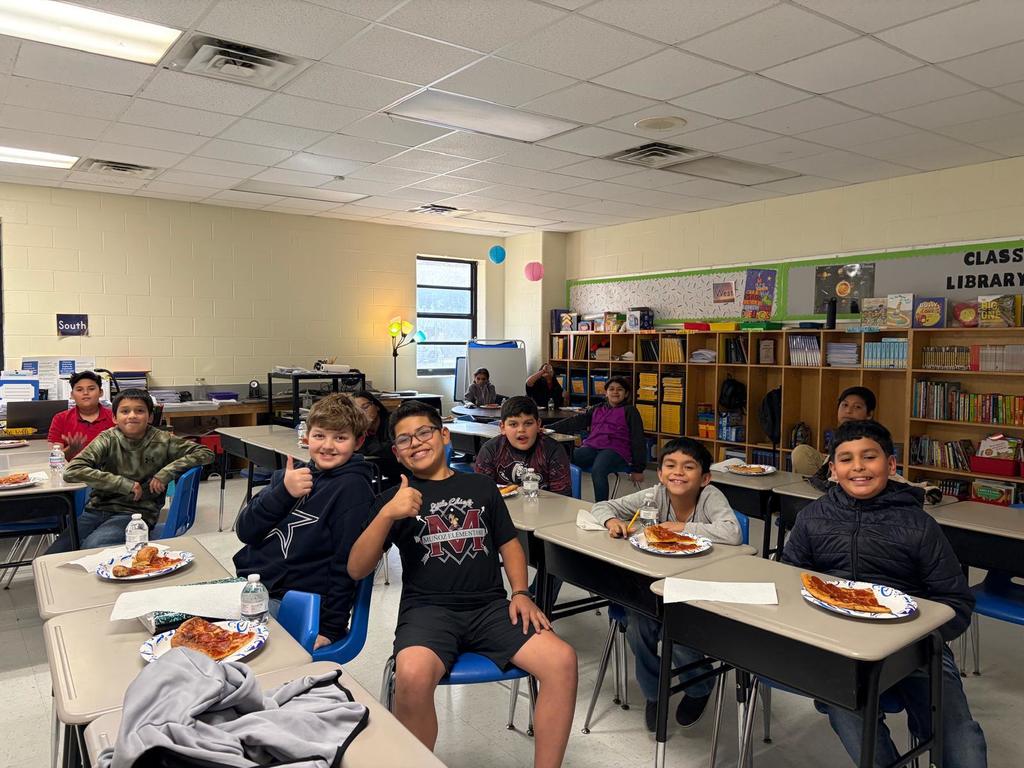 Students celebrating with pizza
