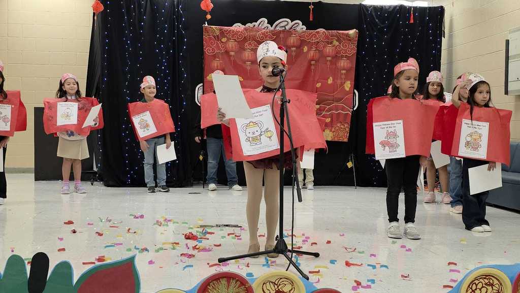 girl in red vest with mic