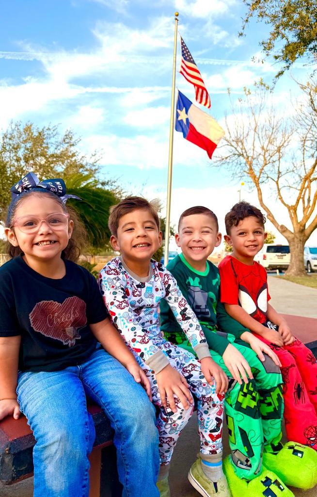 students in front of flag