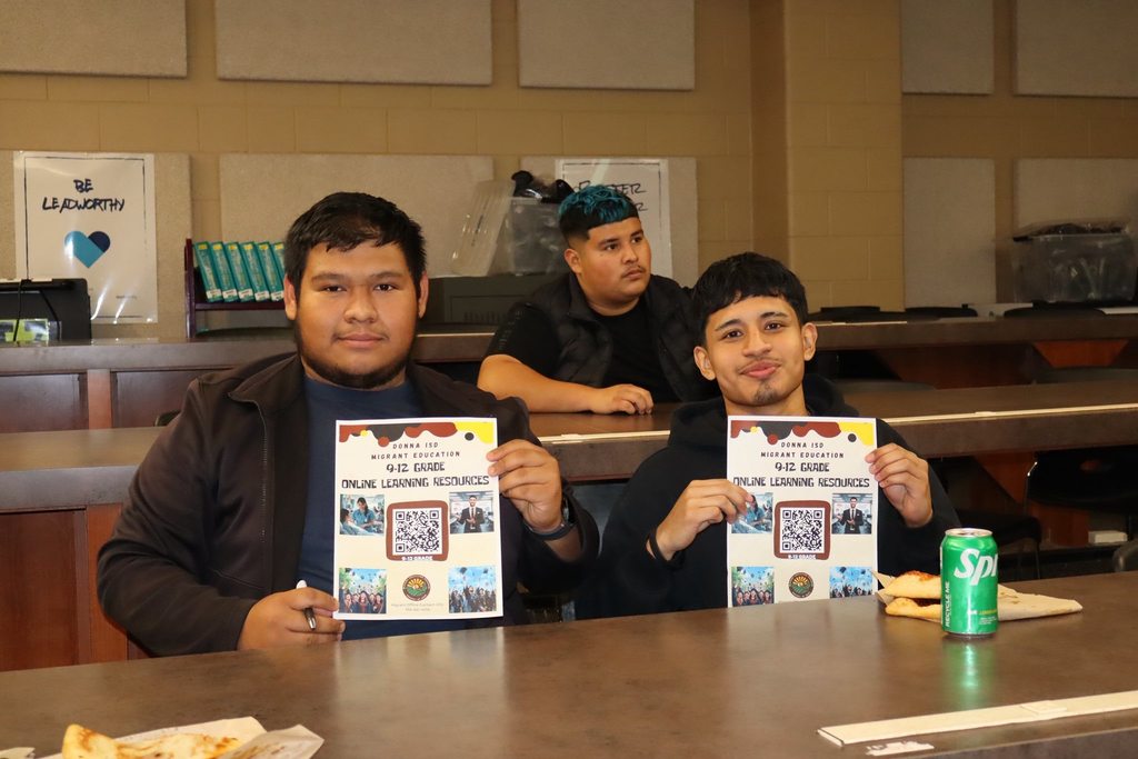 2 male students holding flyer