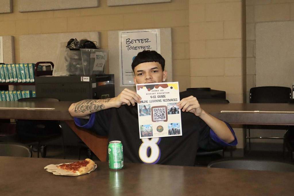 male student holding flyer