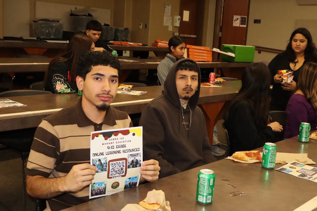 migrant students holding flyer