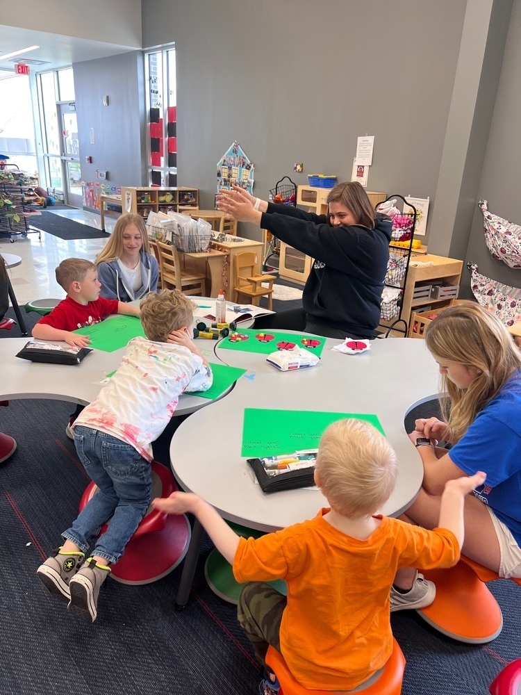 students teaching preschoolers 