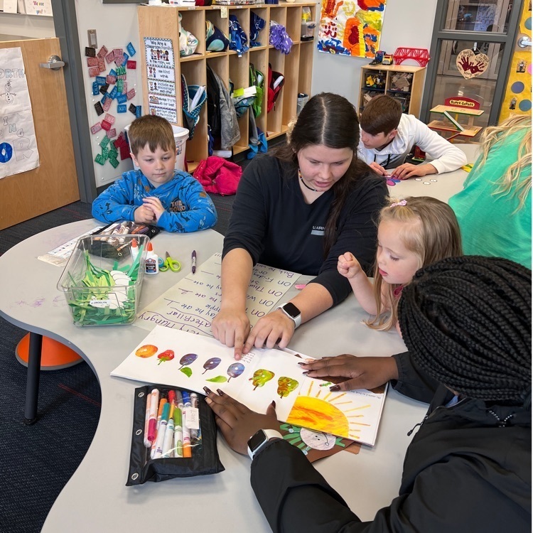 students teaching preschoolers 