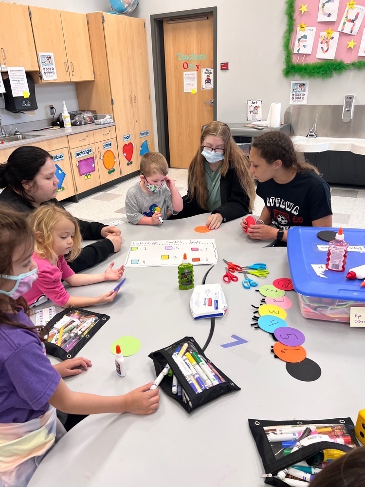 students teaching preschoolers 