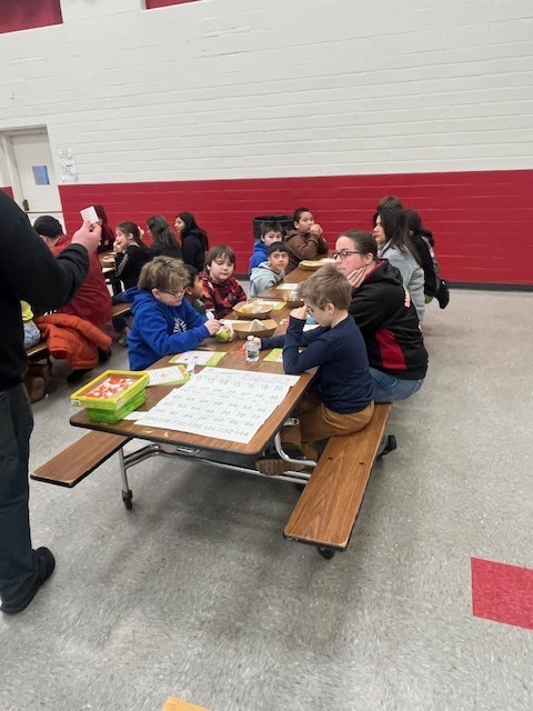 Students learning during breakfast with the teacher 1
