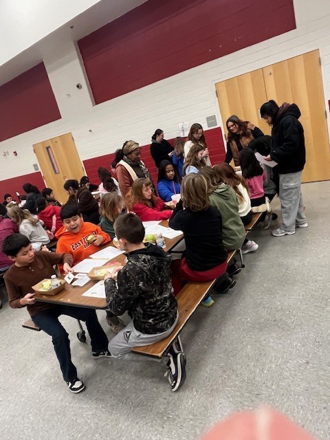 Students learning during breakfast with the teacher 3