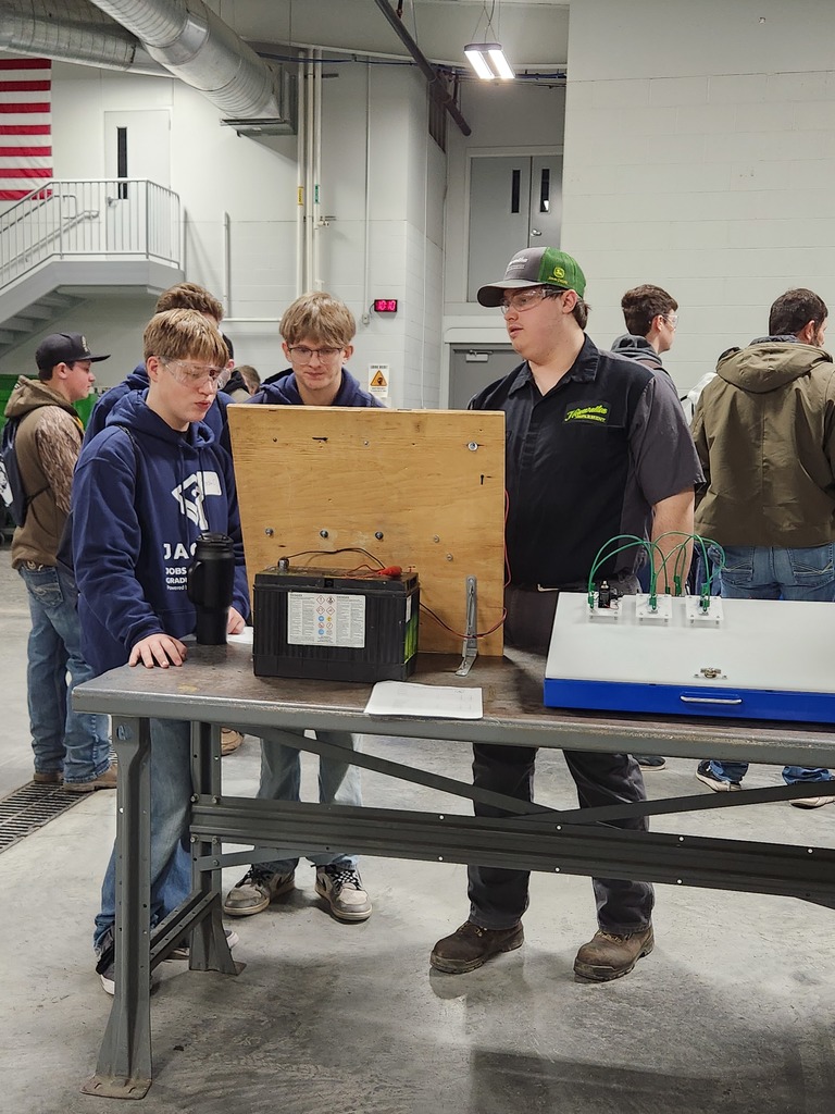 Students engaging in conversation with SCC student to learn more about the classroom tools they use