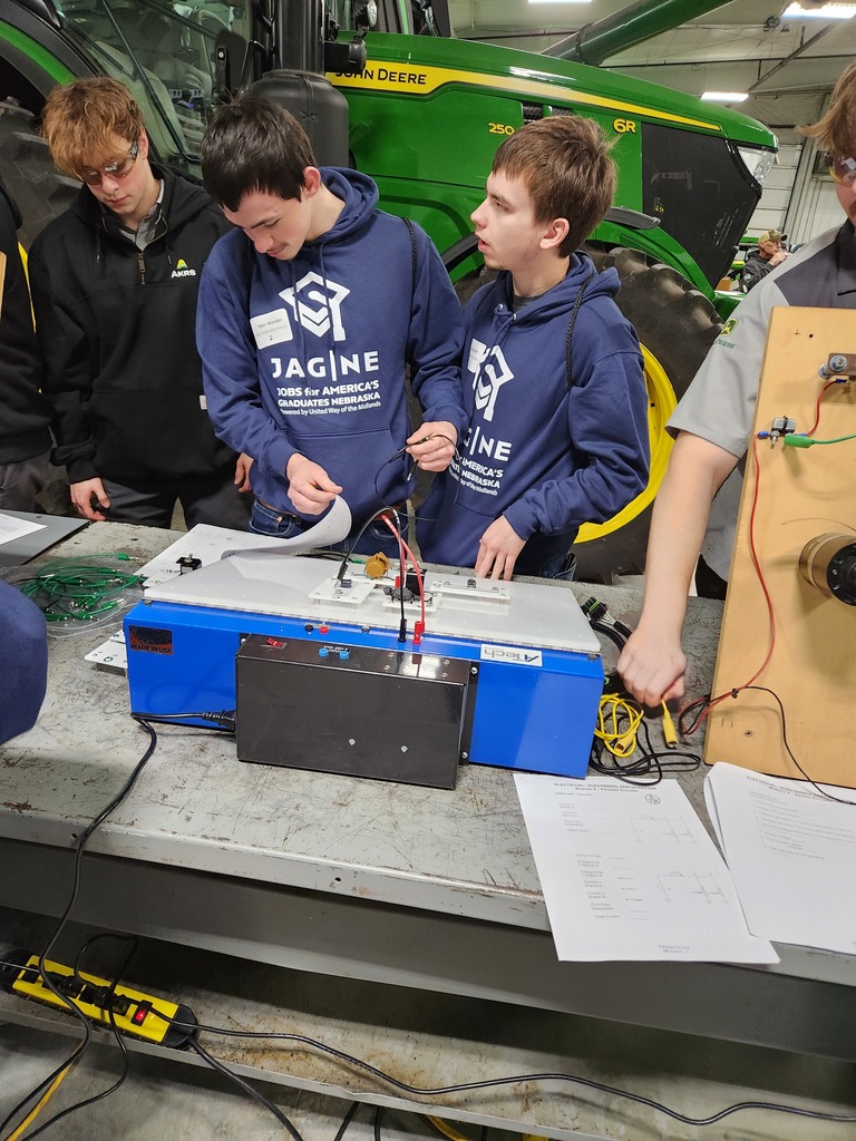 Students trying out the classroom tools SCC students use to learn about electronics and hydraulics.