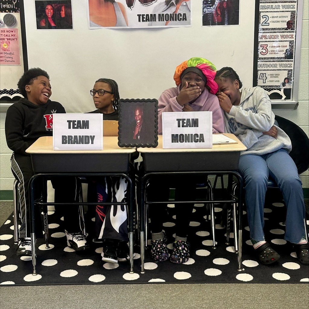 Two young boys on one team sitting on the left and two young girls on another team sitting on the right. 