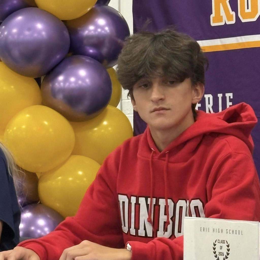 A young boy in a red hoodie.