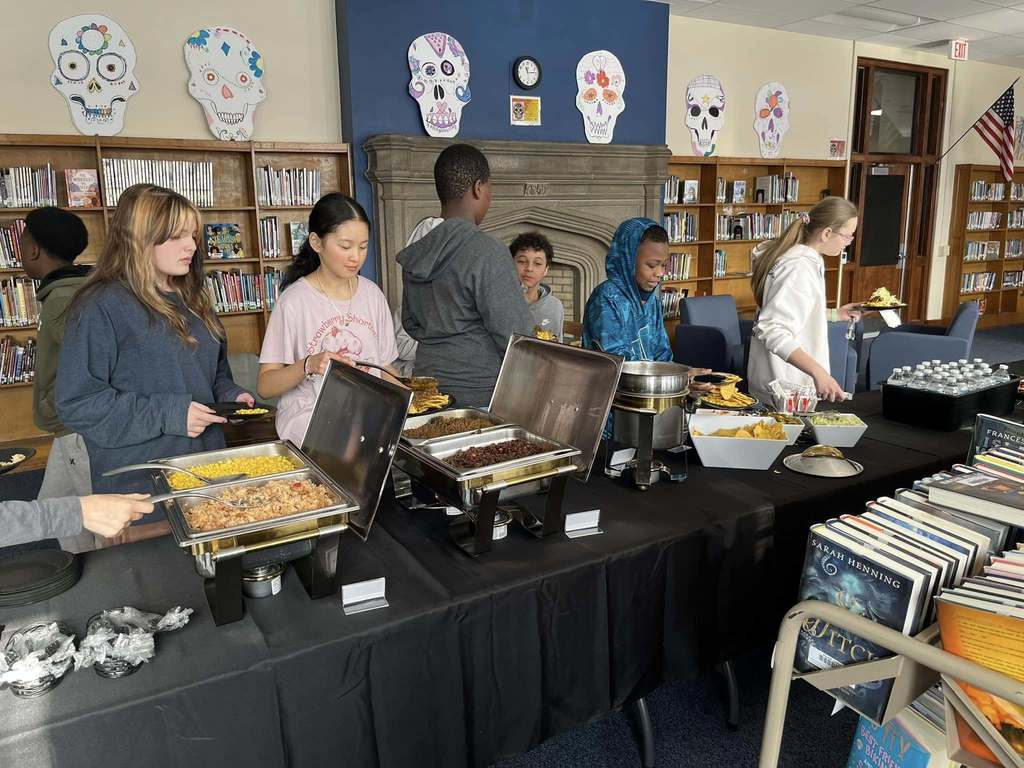 Kids in line getting food. 