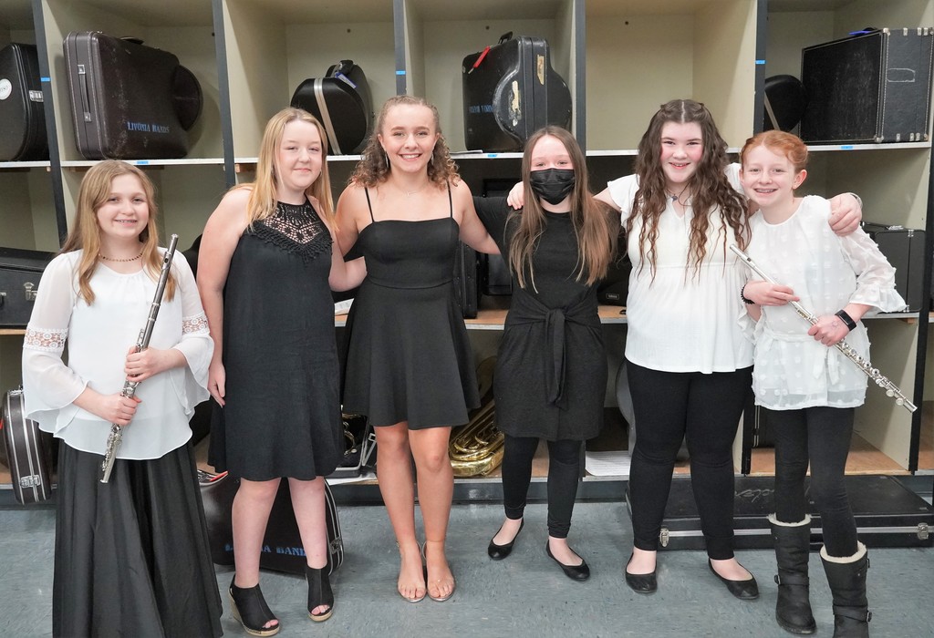 Students in band room with instruments before concert