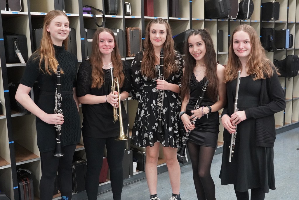 Students in band room with instruments before concert