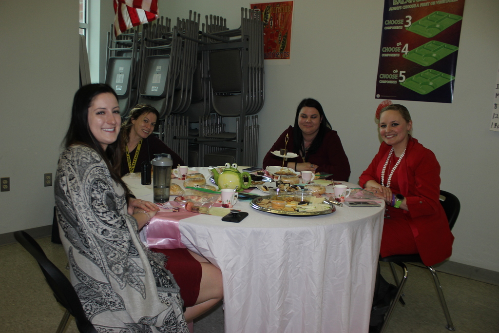staff seated at table with food and drinks