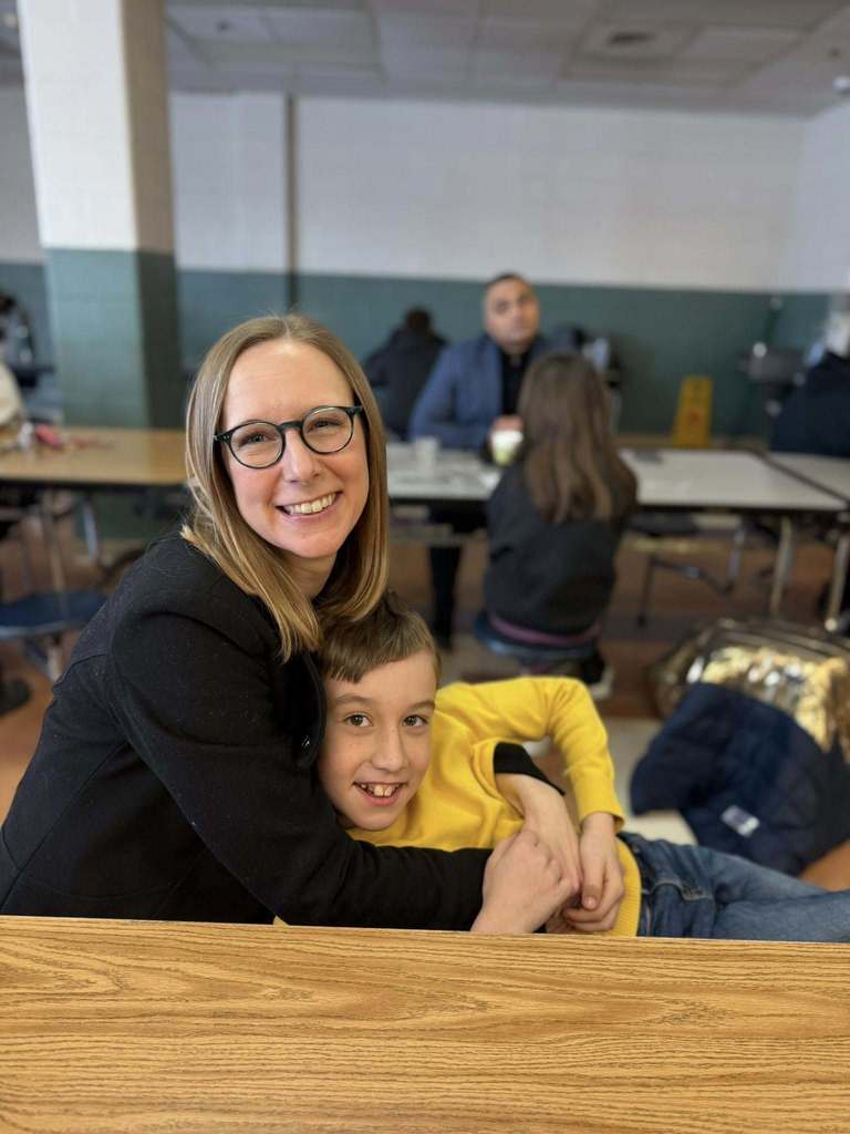 A mom hugging her son.