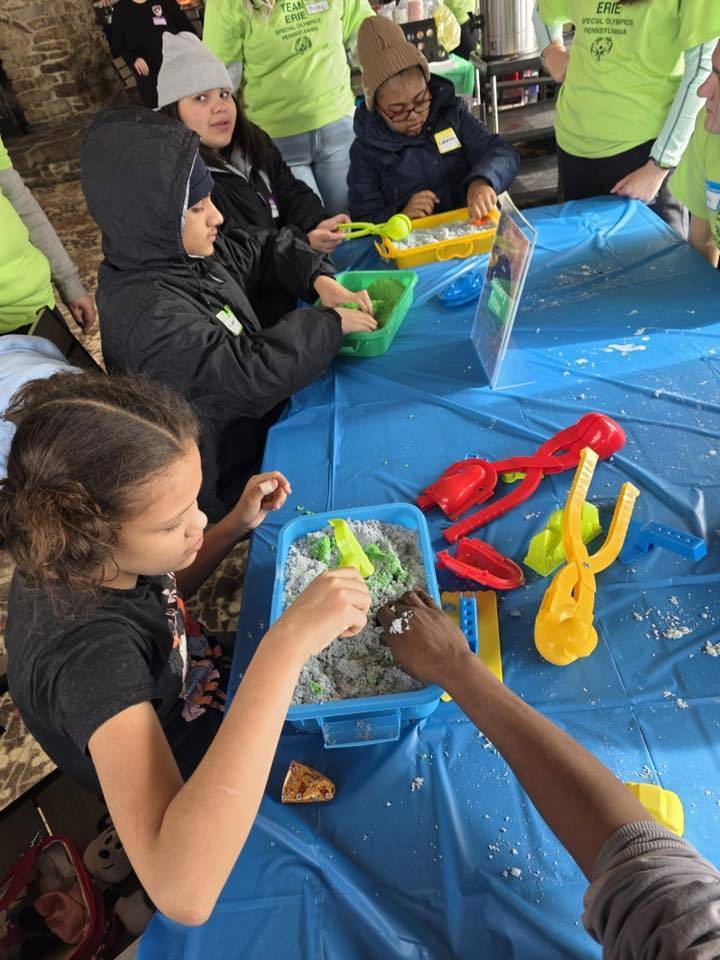 Kids playing with sand and toys.