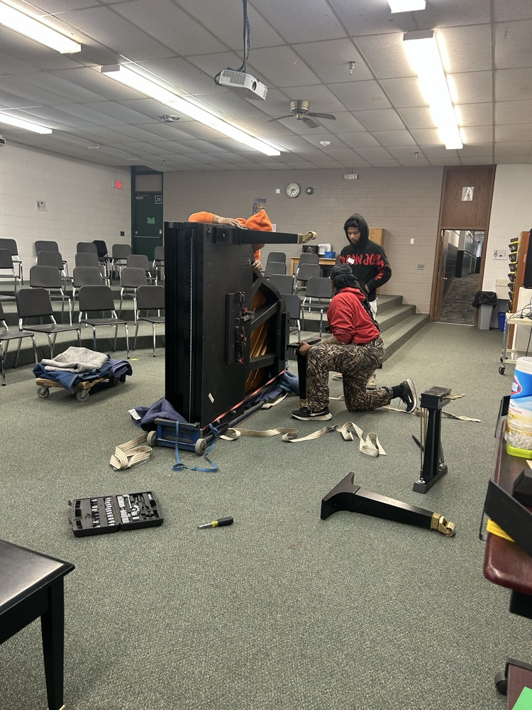 Movers putting the piano together