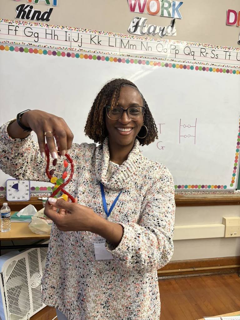 Teacher is holding a design made from candy.