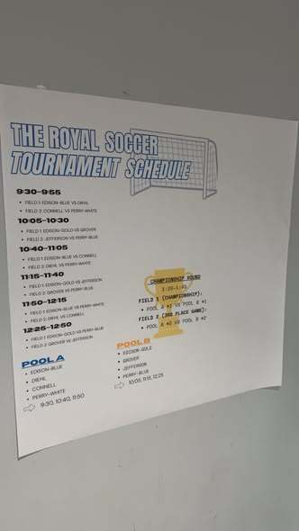 A poster on the wall that says "The Royal Soccer Tournament Schedule".