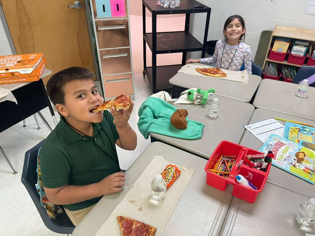 group posing with pizza