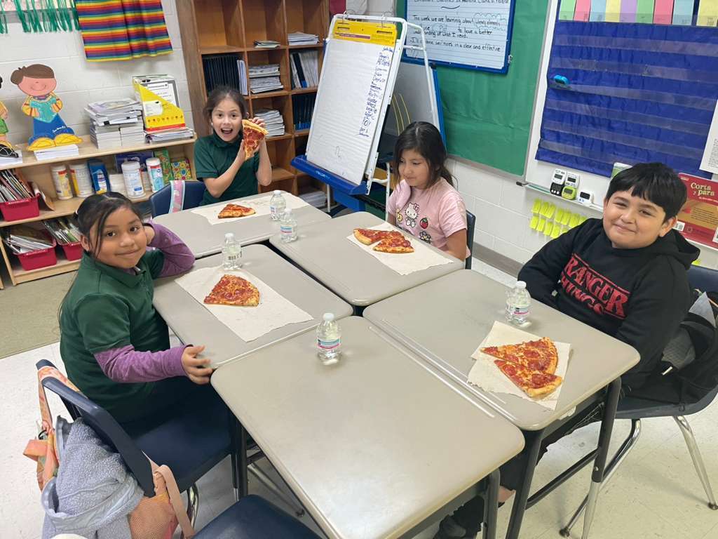 group posing with pizza