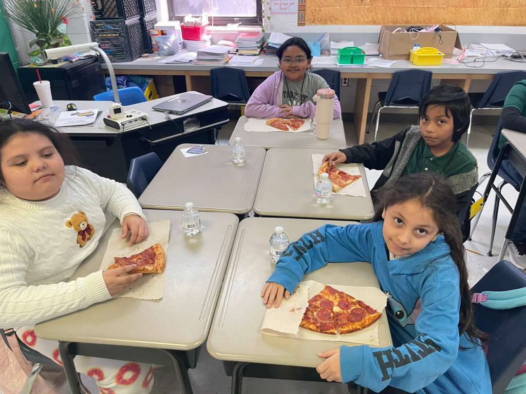 group posing with pizza