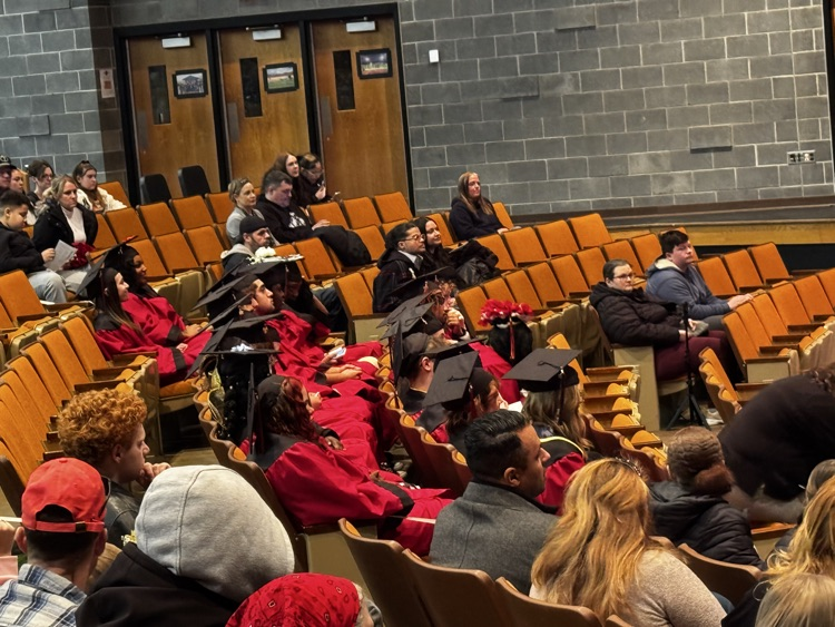 Graduated listening to Mr. Reger prior to turning their tassel.