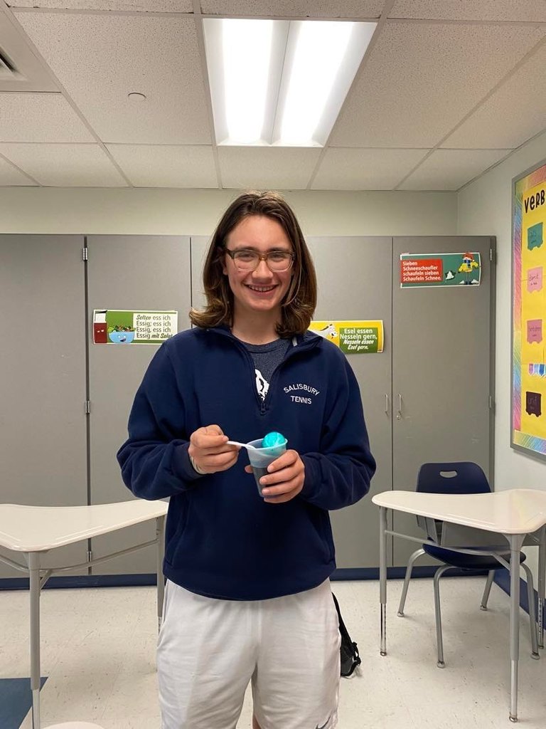 High school students holding their dyed eggs.