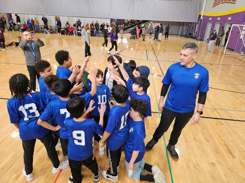 Kid huddling before a game.