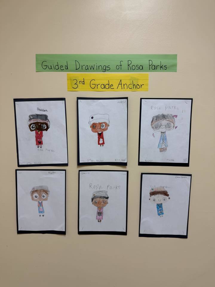 Drawings hanging on a wall.