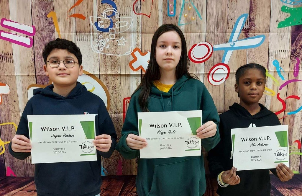 Kids standing and holding their certificates. 