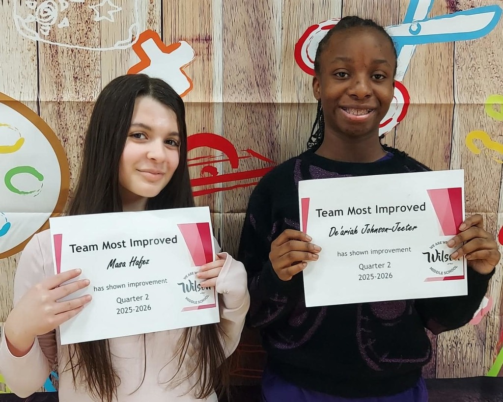 Kids standing and holding their certificates. 