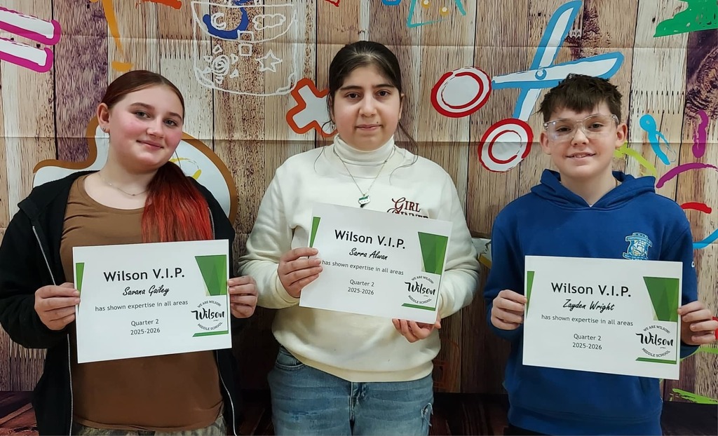 Kids standing and holding their certificates. 