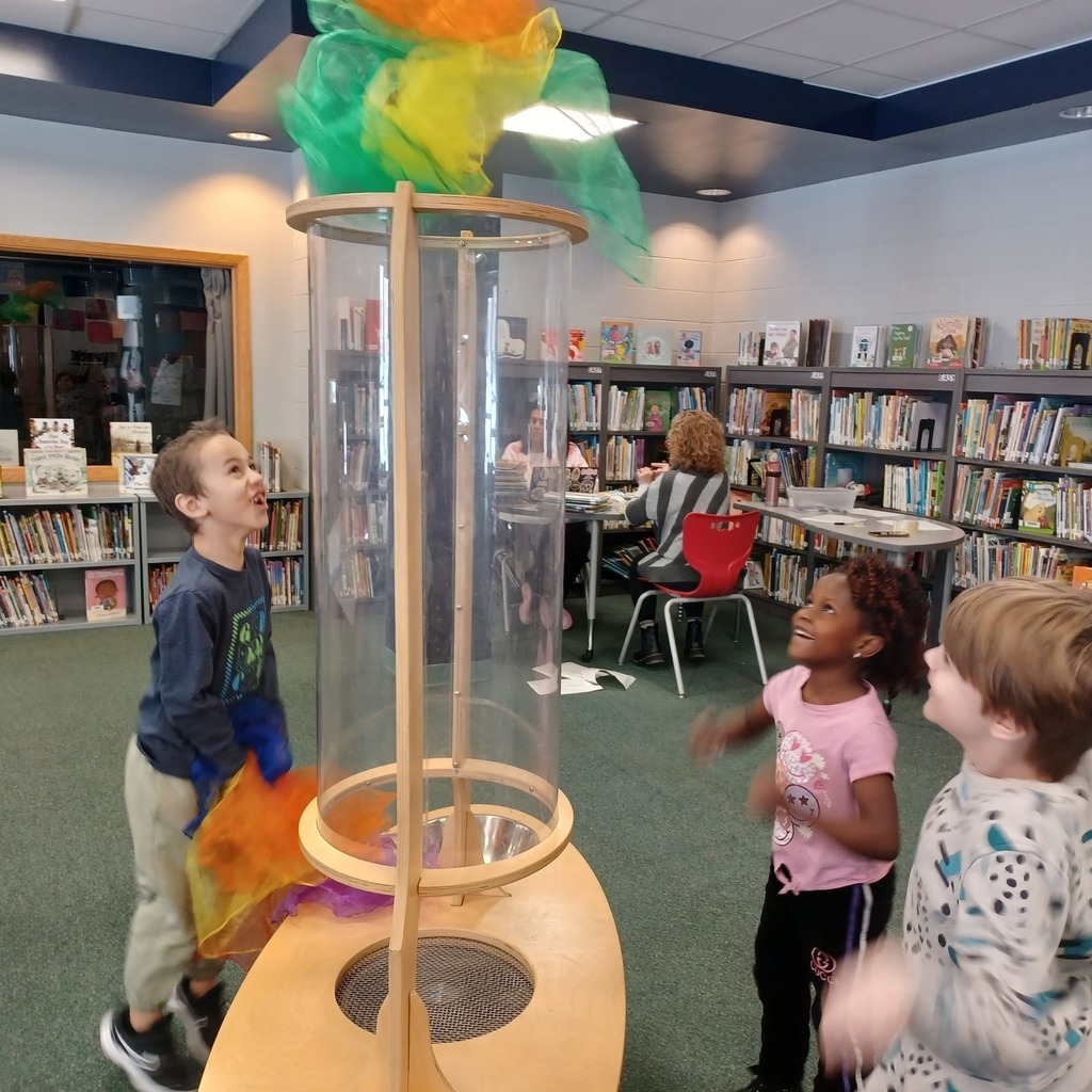 Kids playing in a library.
