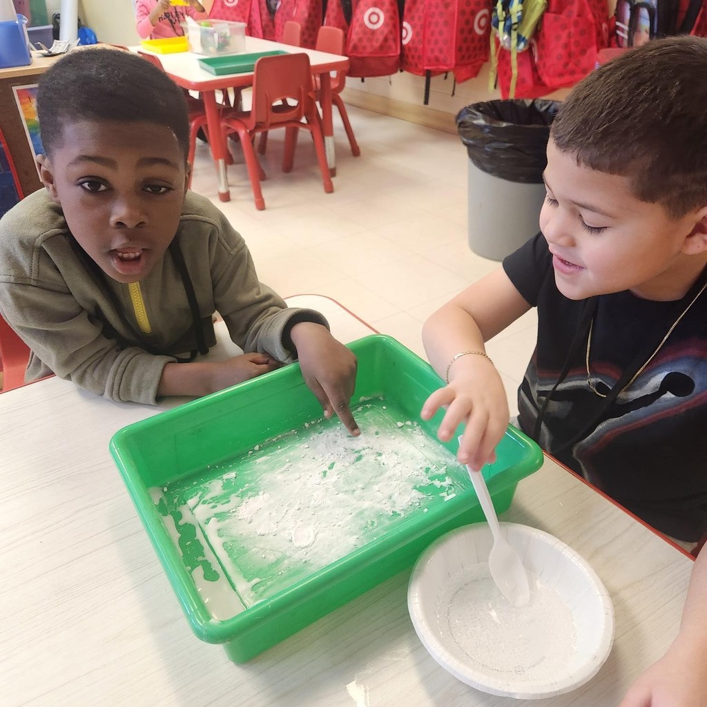 Students looking at the liquid and powder they mixed for an experiment in class.