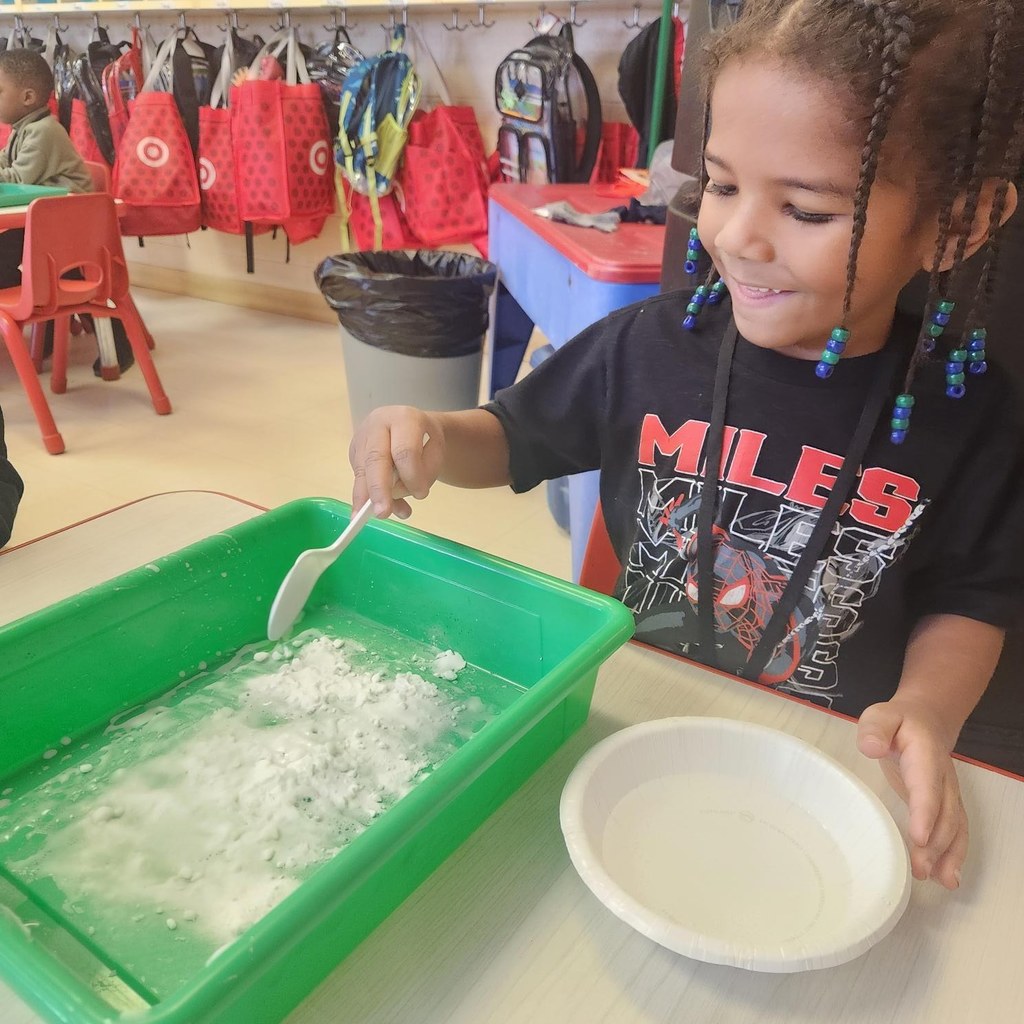 Student mixing liquid and powder for an experiment in class.