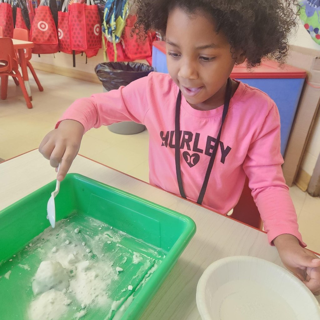 Student mixing liquid and powder for an experiment in class.
