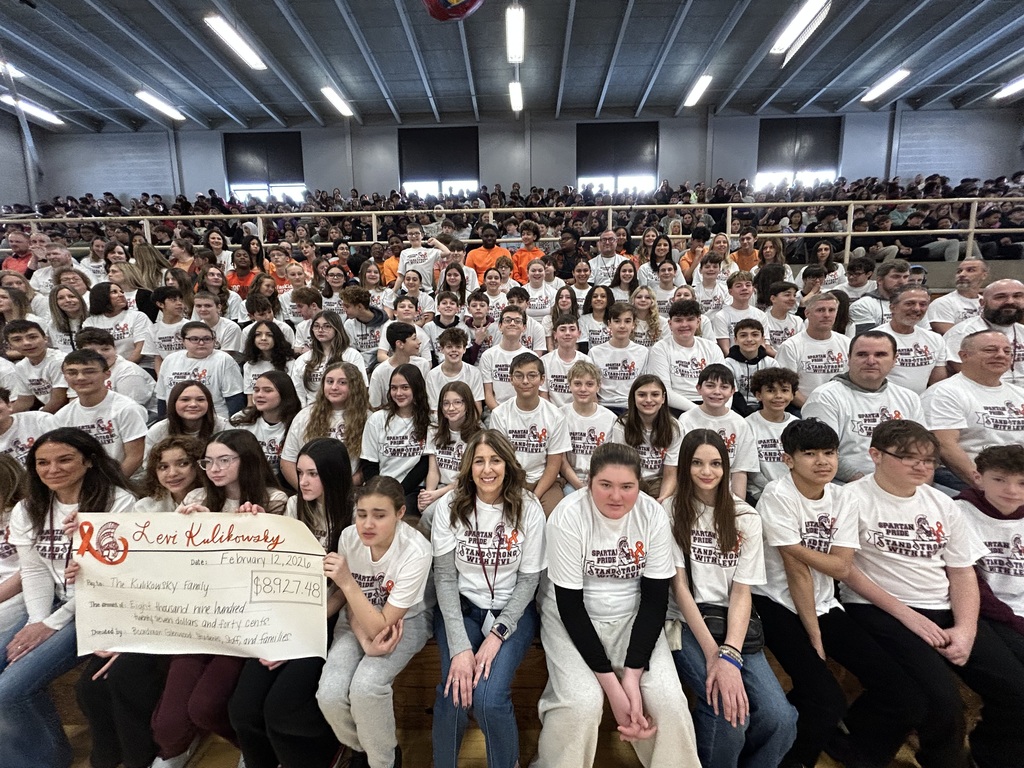 group photo of students wearing stand strong with Levi shirts