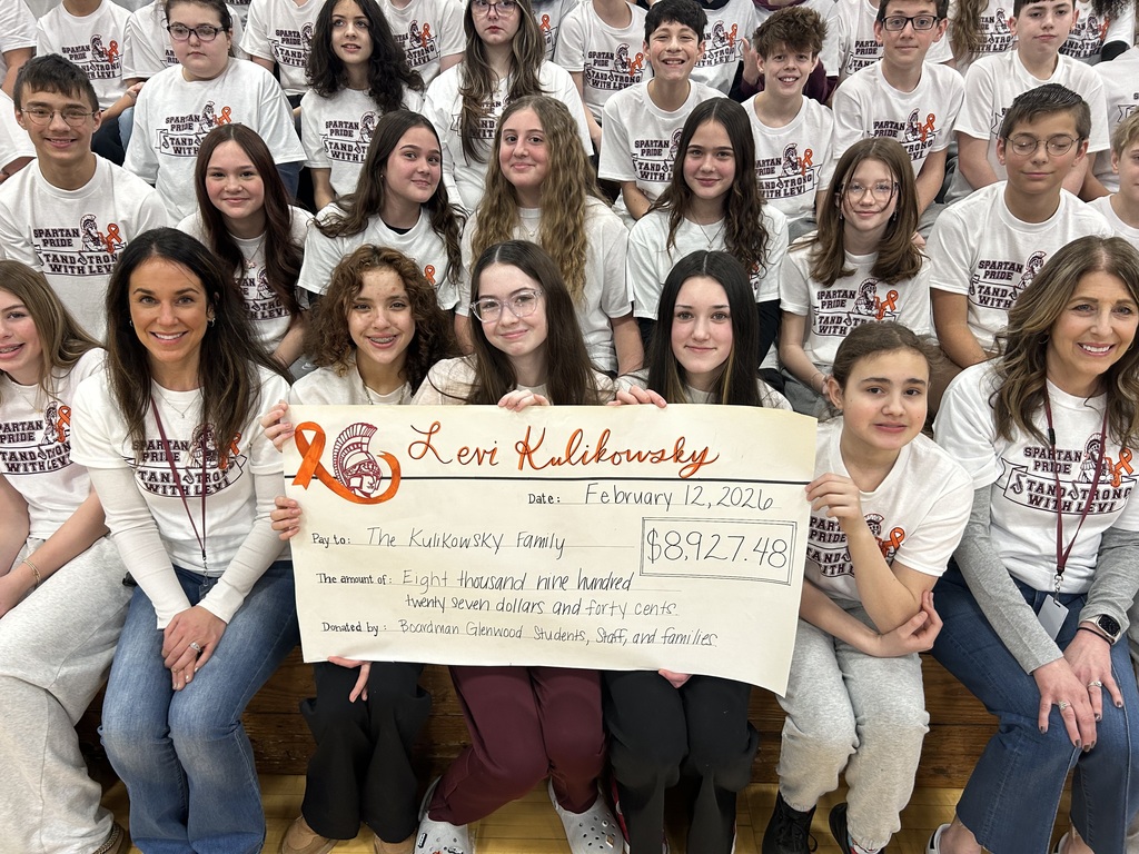 students wearing stand strong with Levi shirts and donation check